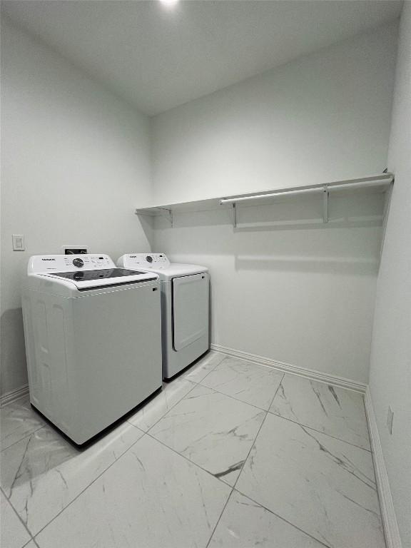 614 S Middle St, Flatonia, TX 78941 - washroom with light marble finish floors, washing machine and clothes dryer, and baseboards