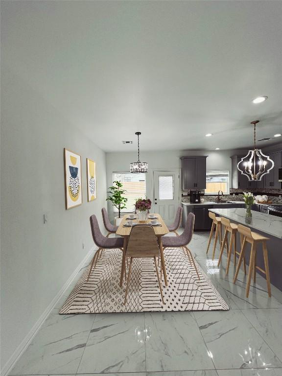 dining area with marble finish floor, baseboards, and a chandelier