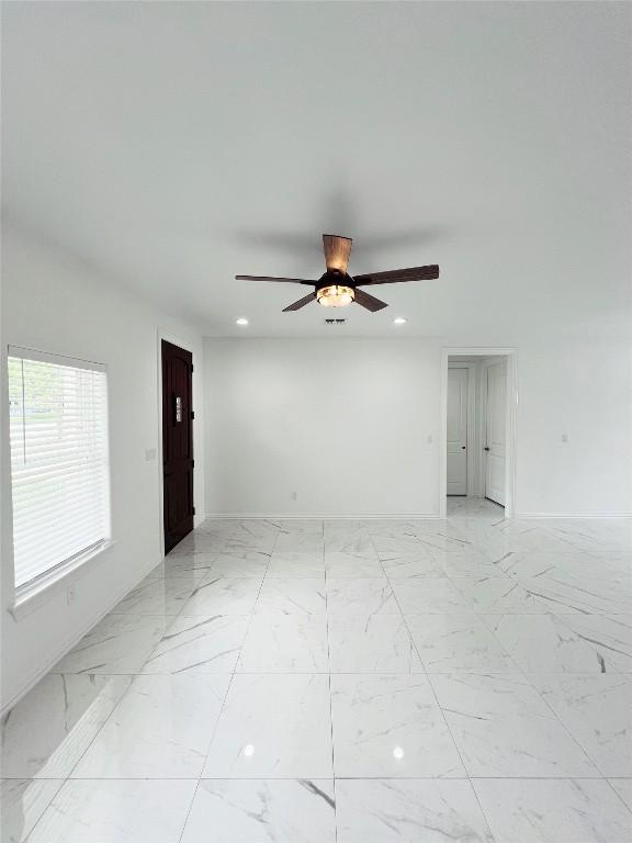 spare room featuring a ceiling fan, baseboards, recessed lighting, and marble finish floor