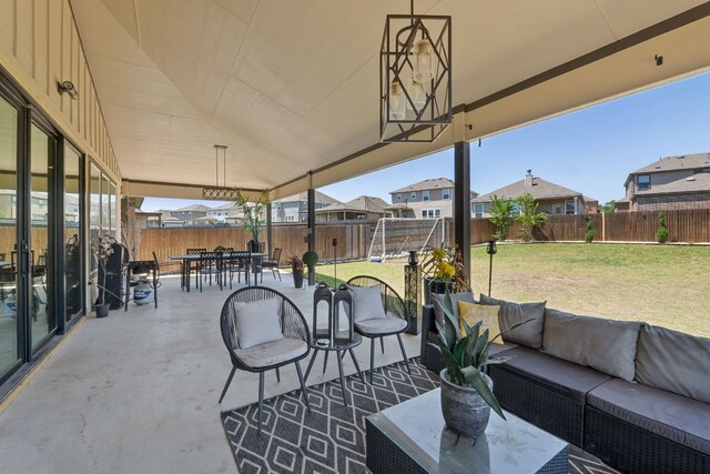 245 Six Shooter Dr, Kyle, TX 78640 - fenced backyard with outdoor lounge area, a patio, a residential view, and outdoor dining space
