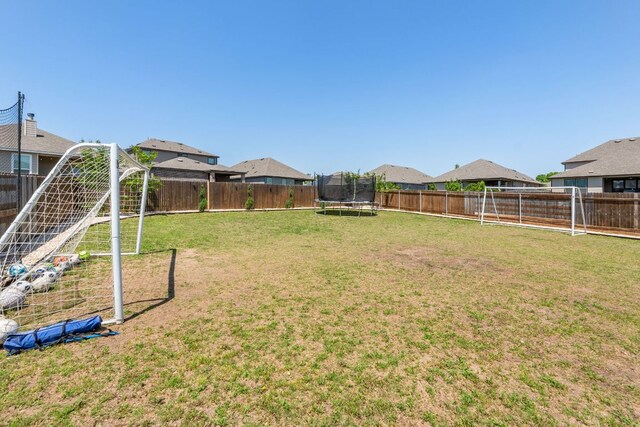 245 Six Shooter Dr, Kyle, TX 78640 - fenced backyard with a trampoline and a residential view