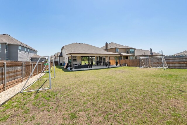 245 Six Shooter Dr, Kyle, TX 78640 - rear view of property with a fenced backyard, a residential view, and a patio