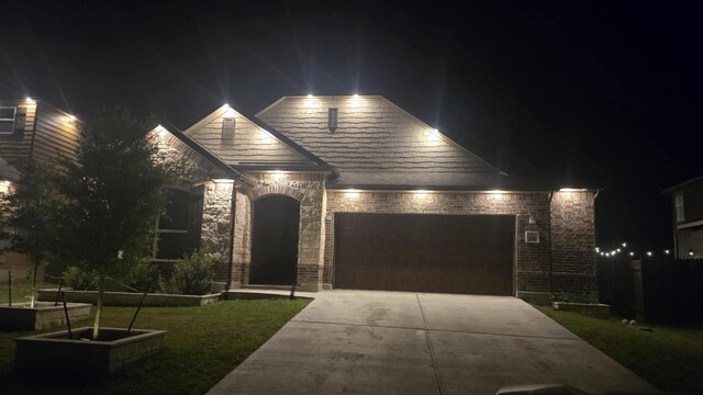 245 Six Shooter Dr, Kyle, TX 78640 - view of front facade featuring driveway, an attached garage, and a lawn