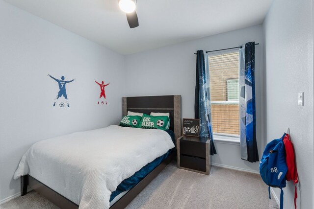 245 Six Shooter Dr, Kyle, TX 78640 - carpeted bedroom featuring multiple windows and ceiling fan