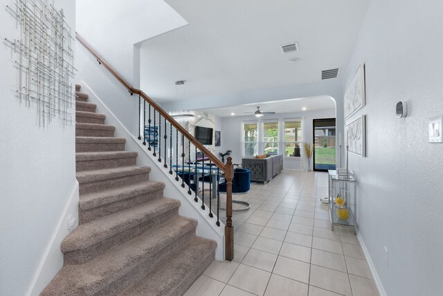 245 Six Shooter Dr, Kyle, TX 78640 - staircase featuring tile patterned flooring, a ceiling fan, arched walkways, and recessed lighting