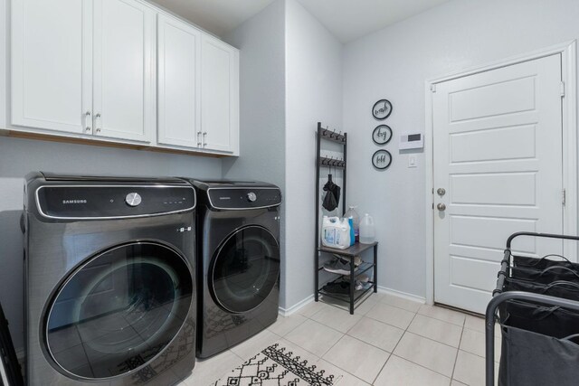 245 Six Shooter Dr, Kyle, TX 78640 - washroom with washer and clothes dryer, cabinet space, and light tile patterned flooring