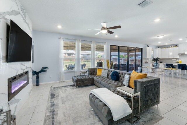 245 Six Shooter Dr, Kyle, TX 78640 - living room featuring light tile patterned flooring, a ceiling fan, and recessed lighting