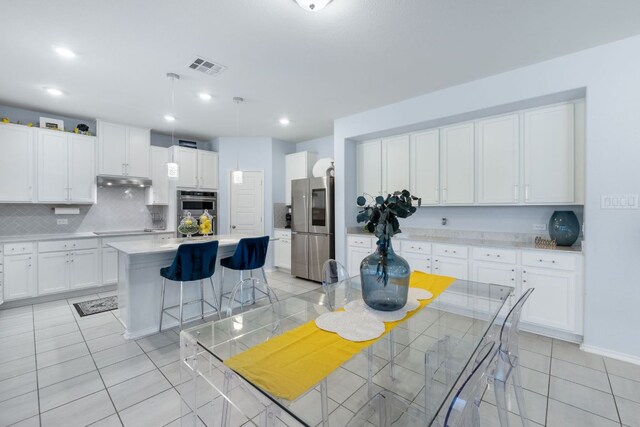 245 Six Shooter Dr, Kyle, TX 78640 - dining area with light tile patterned floors and recessed lighting