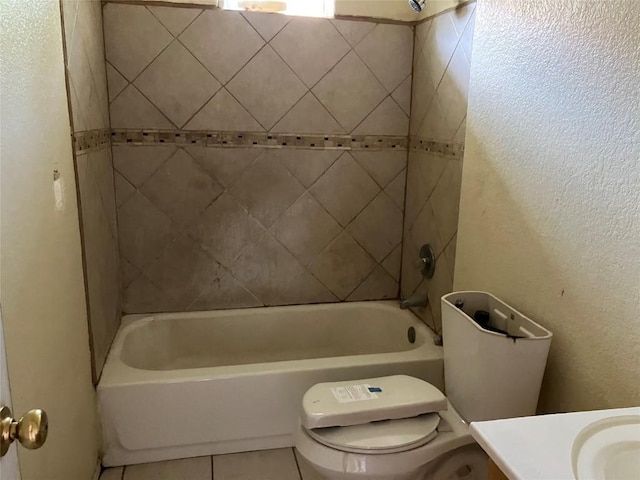 bathroom featuring washtub / shower combination, tile patterned flooring, a textured wall, toilet, and vanity