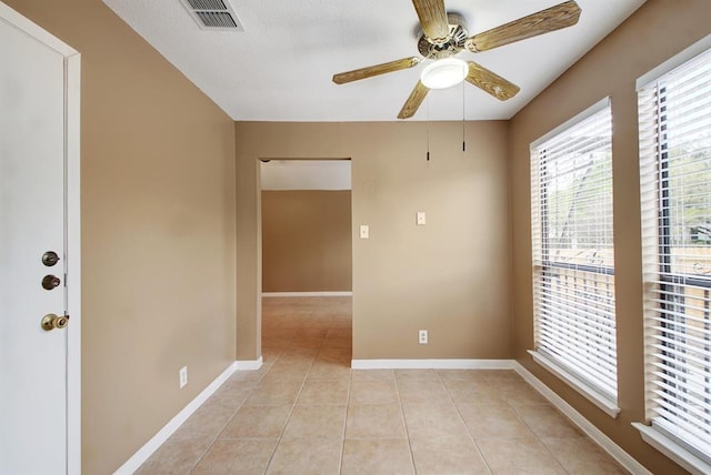 8142 Ceberry Dr Unit B, Austin, TX 78759 - empty room with light tile patterned floors, a ceiling fan, and baseboards