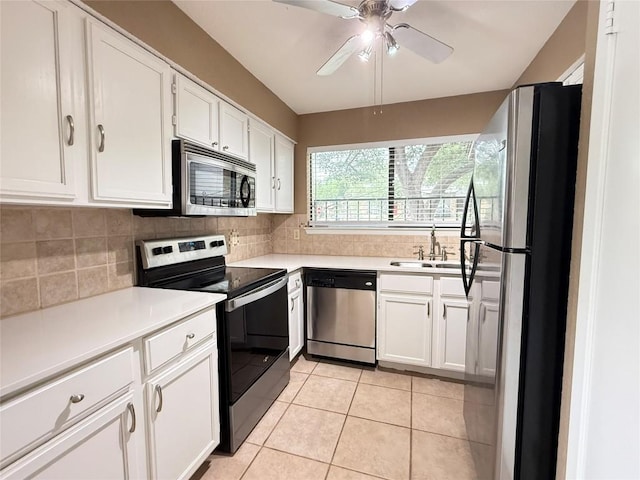 8142 Ceberry Dr Unit B, Austin, TX 78759 - kitchen with stainless steel appliances, a sink, backsplash, light tile patterned floors, and white cabinetry