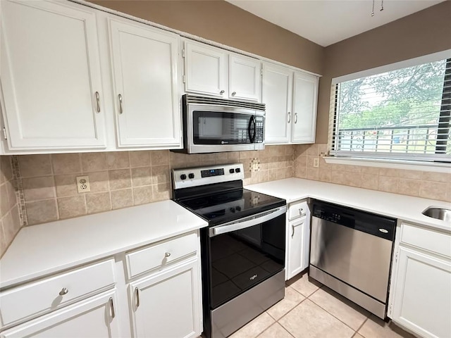 8142 Ceberry Dr Unit B, Austin, TX 78759 - kitchen featuring stainless steel appliances, decorative backsplash, white cabinetry, and light countertops