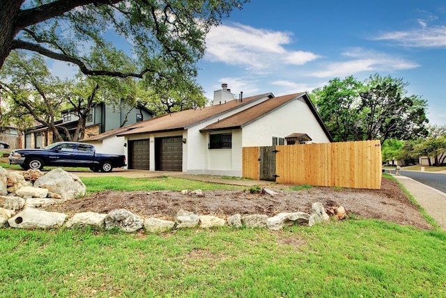8142 Ceberry Dr Unit B, Austin, TX 78759 - view of side of property featuring a garage, driveway, stucco siding, and a chimney