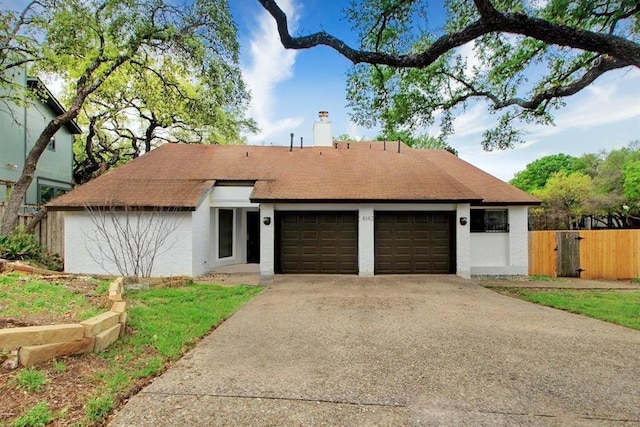 8142 Ceberry Dr Unit B, Austin, TX 78759 - view of front of property with an attached garage, driveway, and a chimney