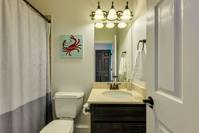 2104 University Club Dr, Austin, TX 78732 - full bath with toilet, vanity, a textured wall, and a shower with shower curtain