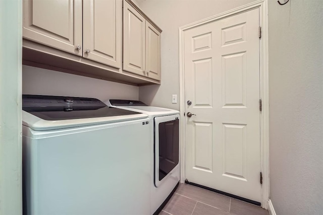 114 Plover Pass, Georgetown, TX 78633 - laundry area with light tile patterned floors, baseboards, cabinet space, and washer and clothes dryer