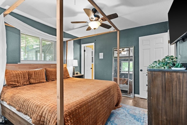 26 N Castleberry St, Lampasas, TX 76550 - bedroom featuring wood finished floors, a textured wall, and a ceiling fan