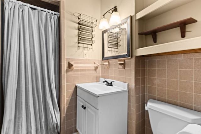 26 N Castleberry St, Lampasas, TX 76550 - full bathroom with tile walls, vanity, curtained shower, and a wainscoted wall