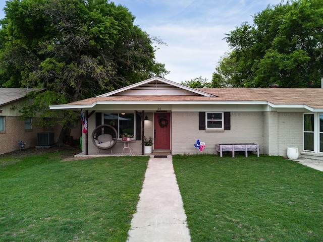 26 N Castleberry St, Lampasas, TX 76550 - view of front facade featuring central AC, a front yard, roof with shingles, and brick siding