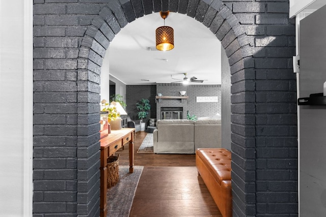 26 N Castleberry St, Lampasas, TX 76550 - corridor with arched walkways, wood finished floors, and brick wall