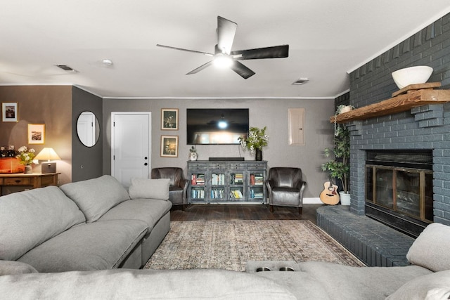 26 N Castleberry St, Lampasas, TX 76550 - living area with ceiling fan, a fireplace, ornamental molding, and wood finished floors