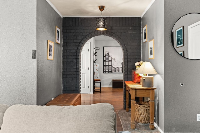26 N Castleberry St, Lampasas, TX 76550 - interior space featuring wood finished floors, arched walkways, and a textured wall