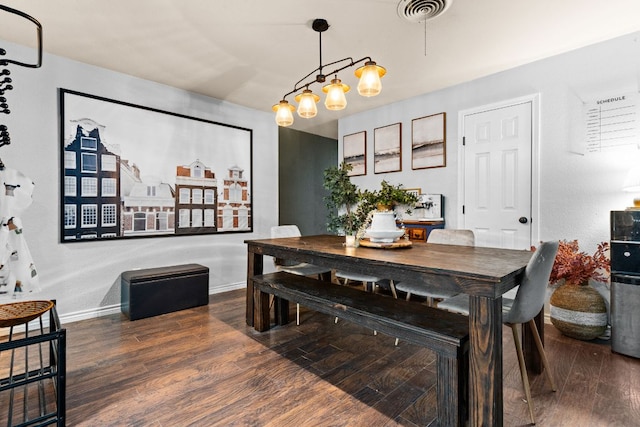 26 N Castleberry St, Lampasas, TX 76550 - dining space featuring a chandelier, baseboards, visible vents, and wood finished floors