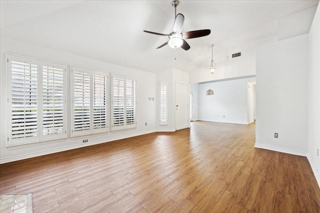 unfurnished living room featuring light wood-style flooring, visible vents, a ceiling fan, and baseboards
