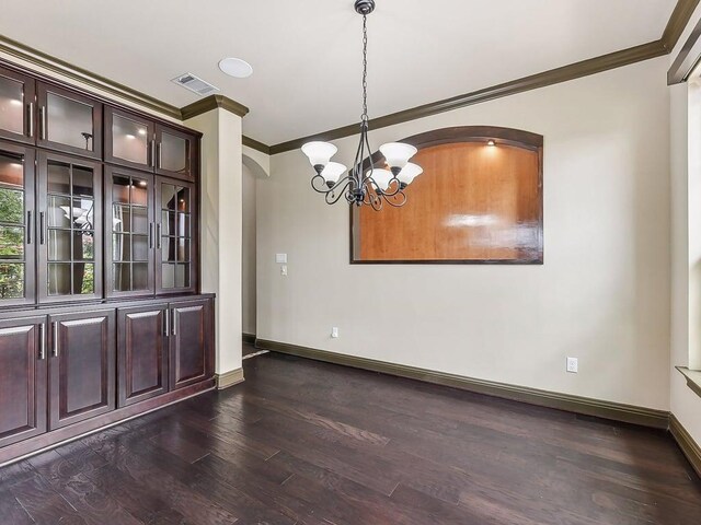 6120 Gunnison Turn Rd, Austin, TX 78738 - unfurnished dining area with ornamental molding, arched walkways, a chandelier, dark wood-type flooring, and baseboards