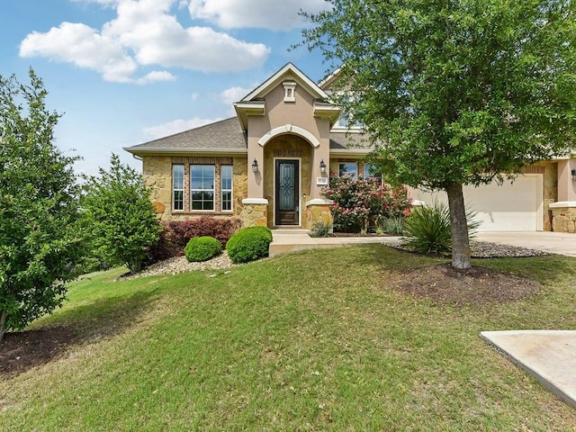 6120 Gunnison Turn Rd, Austin, TX 78738 - view of front of home featuring stone siding, driveway, a front yard, stucco siding, and a garage