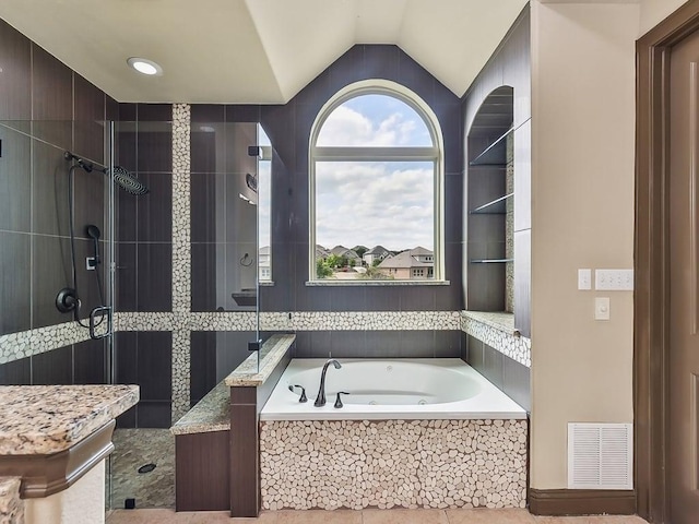 6120 Gunnison Turn Rd, Austin, TX 78738 - full bath featuring tiled shower, a bath, and vaulted ceiling