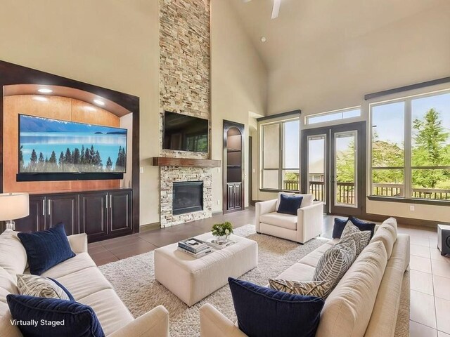6120 Gunnison Turn Rd, Austin, TX 78738 - living room featuring tile patterned flooring, high vaulted ceiling, and a stone fireplace