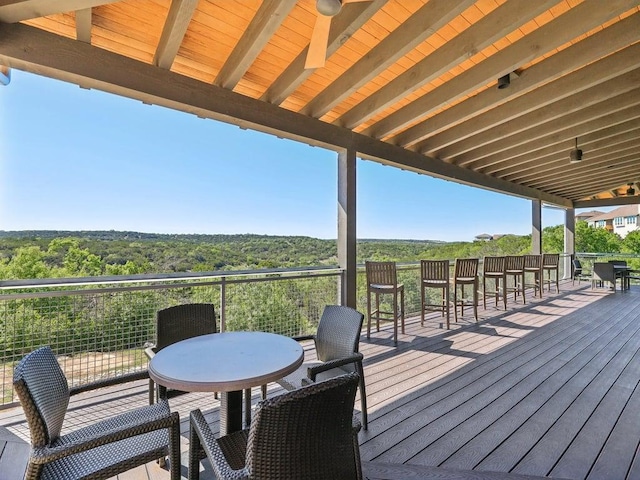 6120 Gunnison Turn Rd, Austin, TX 78738 - wooden deck featuring outdoor dining space and a view of trees