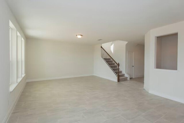 313 Singing Dove Way, Liberty Hill, TX 78642 - empty room with stairway and baseboards