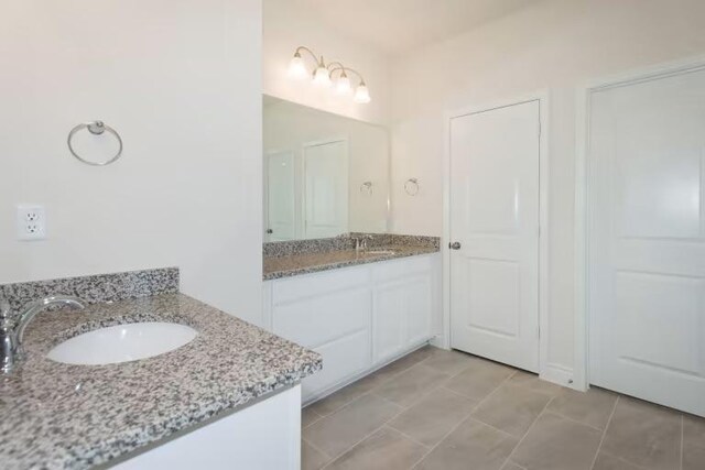 313 Singing Dove Way, Liberty Hill, TX 78642 - full bathroom with two vanities and a sink