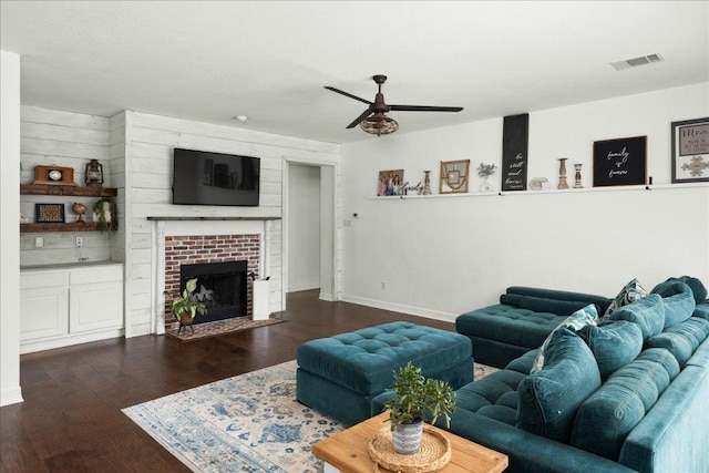 134 Brentwood Dr, Georgetown, TX 78628 - living room featuring ceiling fan, wood finished floors, baseboards, and a brick fireplace
