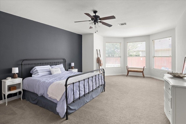 134 Brentwood Dr, Georgetown, TX 78628 - bedroom with light carpet, baseboards, and ceiling fan