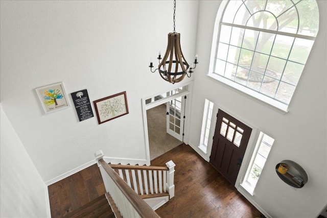 134 Brentwood Dr, Georgetown, TX 78628 - entryway with a chandelier, plenty of natural light, dark wood-type flooring, a high ceiling, and baseboards