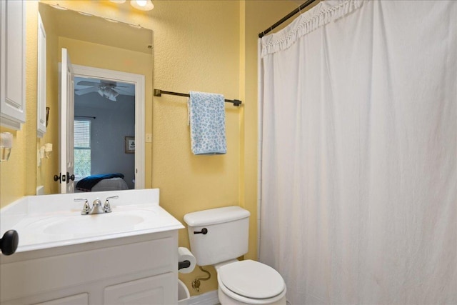 134 Brentwood Dr, Georgetown, TX 78628 - ensuite bathroom with toilet, a ceiling fan, vanity, and a shower with shower curtain