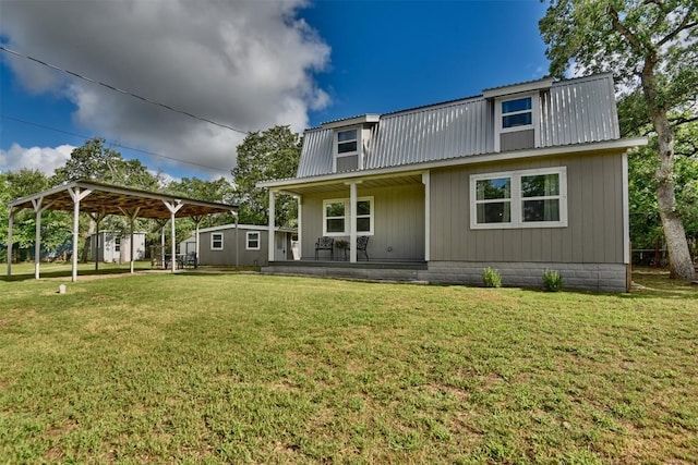 417 Big Bow, Smithville, TX 78957 - back of property featuring metal roof, a yard, and covered porch
