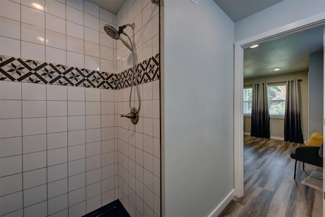 417 Big Bow, Smithville, TX 78957 - bathroom with baseboards, wood finished floors, and tiled shower