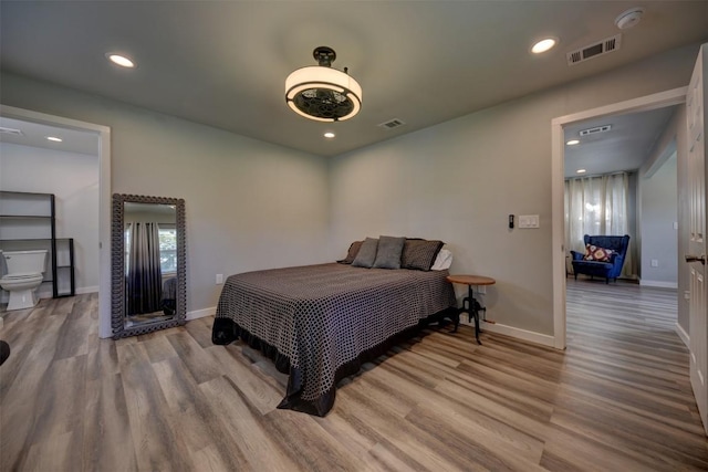 417 Big Bow, Smithville, TX 78957 - bedroom featuring recessed lighting, wood finished floors, visible vents, and baseboards
