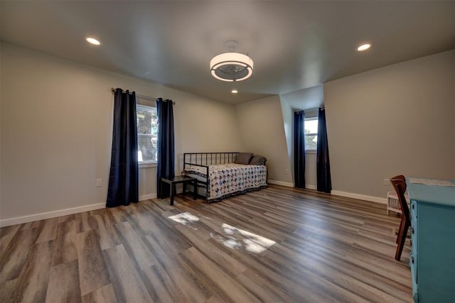 417 Big Bow, Smithville, TX 78957 - bedroom with baseboards, wood finished floors, and multiple windows