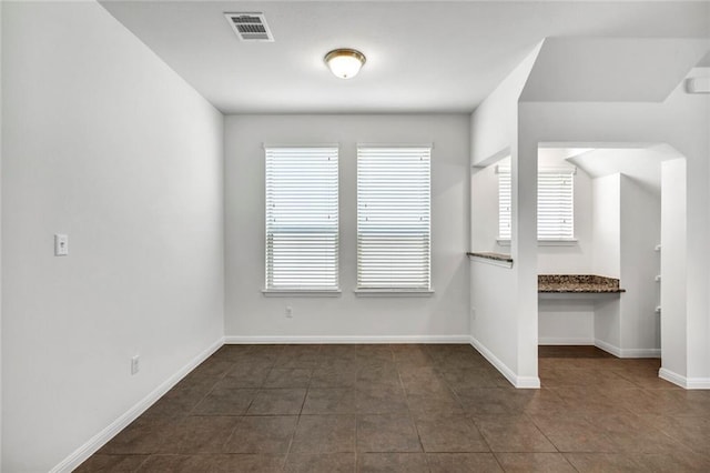 265 Spanish Star Trl, Dripping Springs, TX 78620 - unfurnished room featuring dark tile patterned floors and baseboards