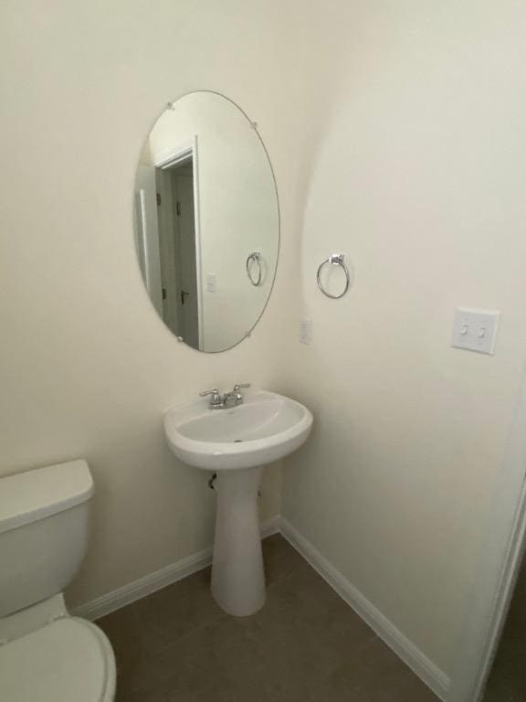 265 Spanish Star Trl, Dripping Springs, TX 78620 - half bathroom with toilet, tile patterned floors, baseboards, and a sink
