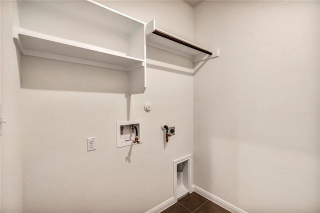 265 Spanish Star Trl, Dripping Springs, TX 78620 - washroom with gas dryer hookup, hookup for an electric dryer, washer hookup, baseboards, and dark tile patterned flooring