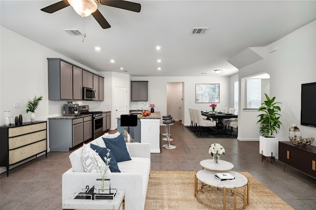 265 Spanish Star Trl, Dripping Springs, TX 78620 - tiled living room with a ceiling fan and recessed lighting