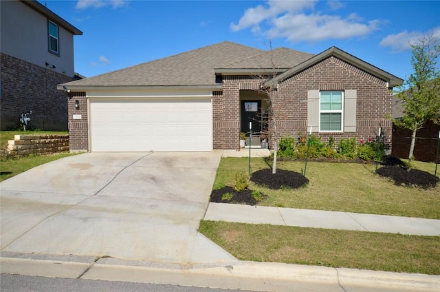 2504 Indian Clover Trl, Leander, TX 78641 - view of front of property featuring brick siding, an attached garage, concrete driveway, a front yard, and roof with shingles