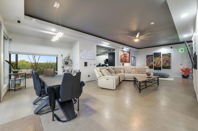 living room with finished concrete flooring, a raised ceiling, a ceiling fan, and recessed lighting