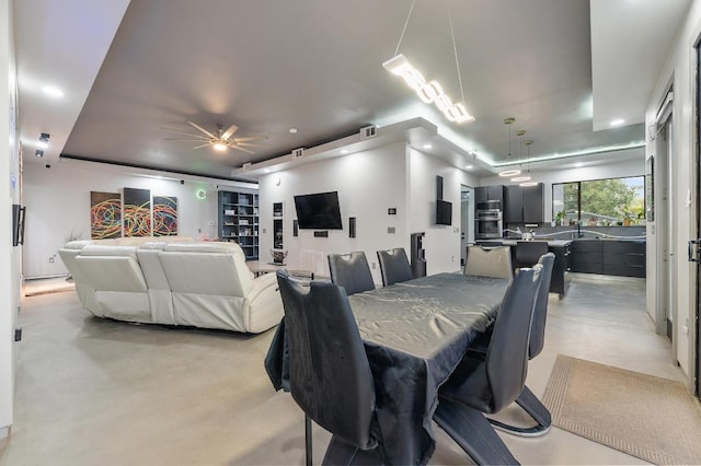 dining area featuring ceiling fan, recessed lighting, and concrete flooring